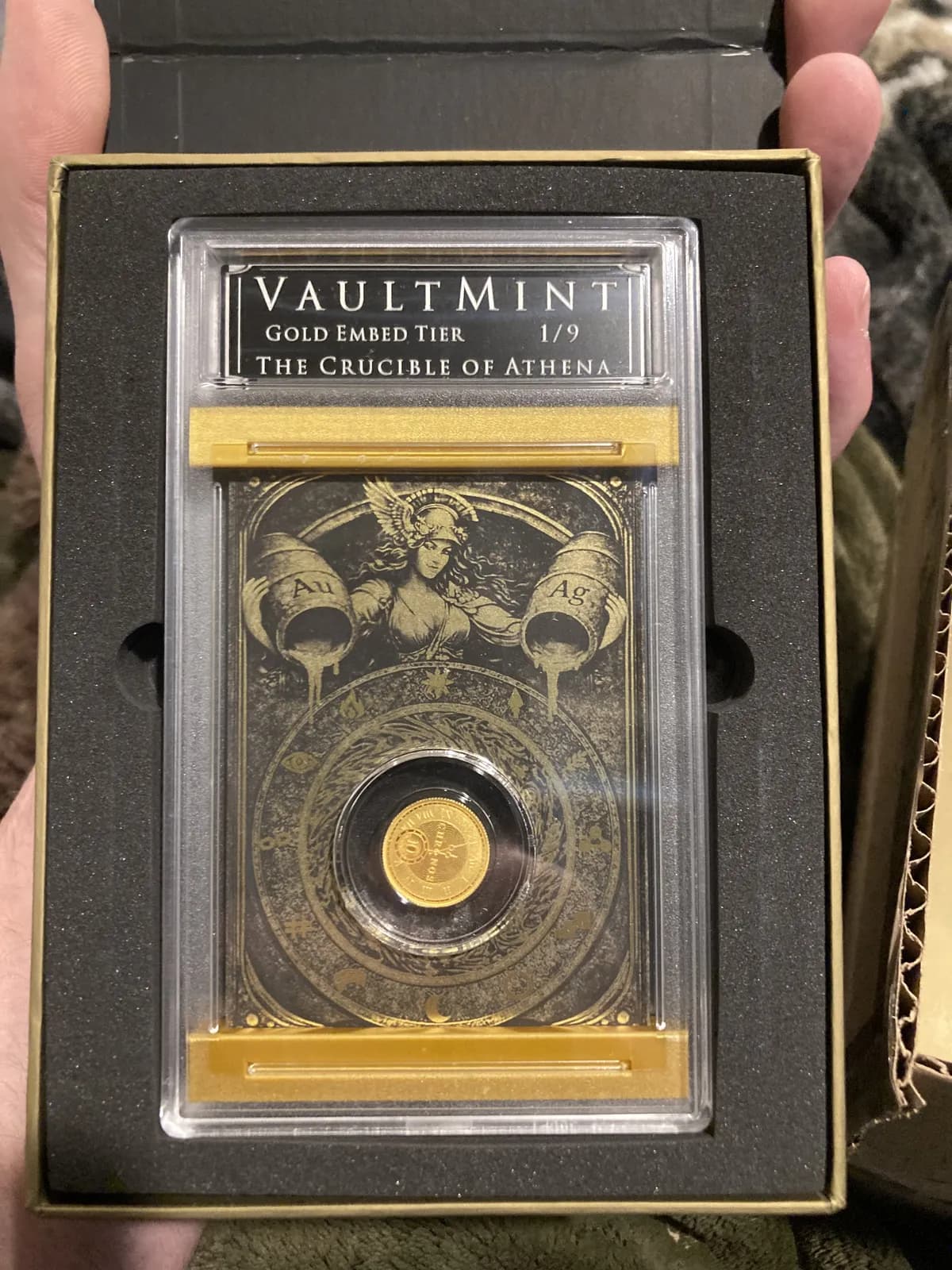 The pulled Gold Alpha: The Crucible of Athena, Gold Embed Tier 1 of 9, slabbed with its embedded gold coin